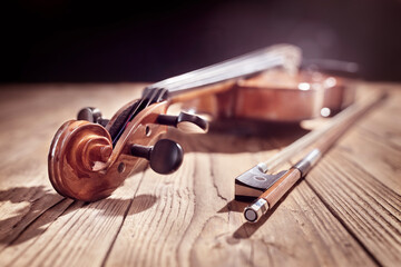 Violin and bow on wood background for music concept