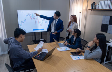 Fototapeta premium Team presents financial data and analysis during a business meeting in a modern office setting