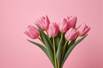 there is a vase with pink flowers in it on a pink background