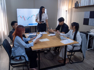 Business meeting with a presentation on financial data in a modern office setting