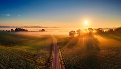 Fototapeta premium Sunrise during Morning Mist Farm Road Landscape HDR XXXL