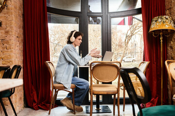 Young man enjoys leisure time at a cozy cafe while connecting digitally with others