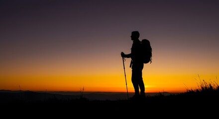 Hiker silhouette sunset mountain peak.