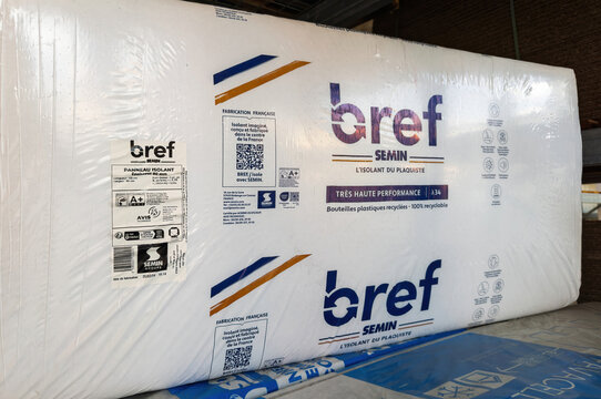 Paris, France - Mar 27, 2025: Packaged SEMIN Bref insulation panels made from recycled plastic bottles, labeled for high performance and sustainability, stacked in a sheltered section of a DIY store.