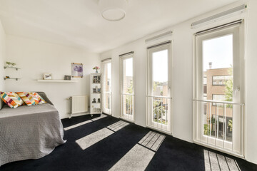 A modern living room filled with natural light, featuring large windows, cozy decor, and stylish furniture, creating an inviting atmosphere.