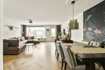 A contemporary living room featuring elegant furniture and vibrant wall art, showcasing a blend of comfort and aesthetics in interior design.
