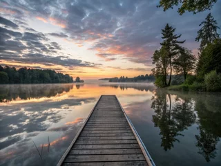 Printed kitchen splashbacks Serene sunrise hues reflected in a calm lake, a lone jetty mirroring the heavens.