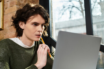 Engaging young guy immersed in creative thoughts at a cozy cafe during a leisurely afternoon
