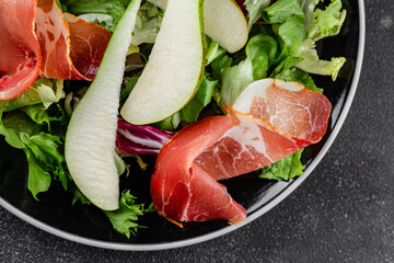 Salad pear ham vegetable dish fresh tasty gourmet food background on the table rustic food top view copy space