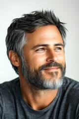 Fototapeta premium A modern hairstyle complementing a stylish gentleman. Chic men's high and tight haircut - midlife white man with hair. Pure white solid background. Creative of style for aging men.