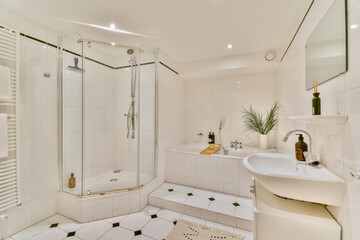 A sleek modern bathroom featuring a glass shower, elegant fixtures, and stylish decor, creating a serene and inviting atmosphere.