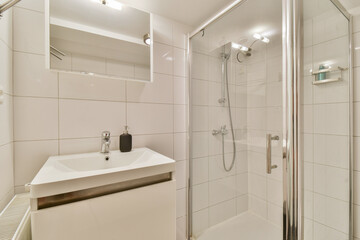 Features a sleek, modern bathroom setup showcasing a shower stall alongside a minimalist sink and...