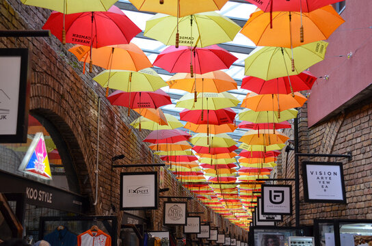 London, England, United Kingdom - octuber 2024: Colorful umbrellas provide shade and shelter to shoppers at Camden Market in London