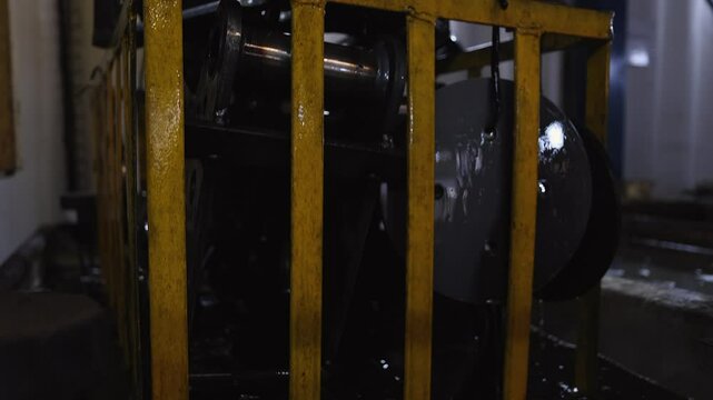 Basket of heavy steel implement parts removed from cleaning solvent