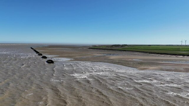 Row of Barges on River Blackwater Essex UK used for WW2 target practice