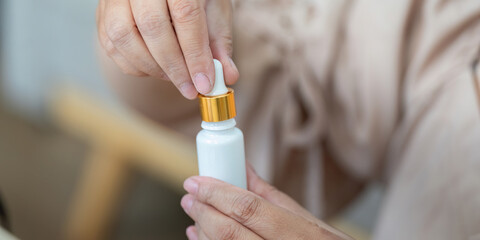Beauty and Application Technique. Preparing a dropper for skincare application.