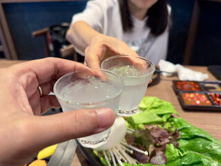 A lovely or a couple family Cheers Over Korean BBQ with Soju Shots.