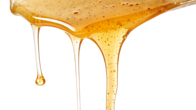 Honey dripping from a spoon on transparent background