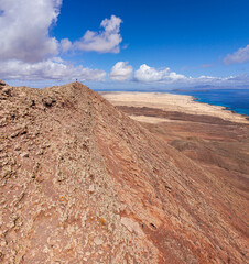 Dramatic aerial image of Montana Roja the volcanic mountains landscape and coastline near Corralejo in Fuerteventura Canary Islands Spain	