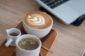 Business workspace for entertainment media with laptop, headphones and coffee cup on morning desk