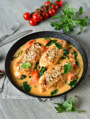 Chicken breast in creamy sauce with tomatoes and spinach