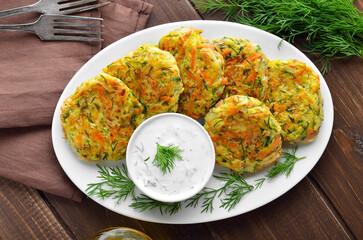 Diet vegetable cutlet from zucchini, carrot, herbs on white plate