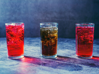 A lot of Soft drinks in colorful and flavorful glasses on the table,Glasses with sweet drinks with ice cubesv
