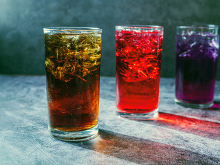 A lot of Soft drinks in colorful and flavorful glasses on the table,Glasses with sweet drinks with ice cubesv