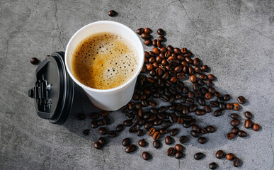 Coffee crema espresso in paper Coffee cup and bean on gray background, Top view of Espresso in  Takeaway paper coffee cup.