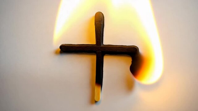 Crossmark design created with matchsticks on textured linen background.