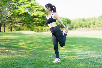 Asian woman is stretching her arms and body before exercise.