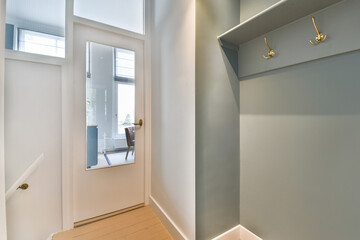 A stylish entryway featuring minimalistic design elements, showcasing clean lines, soft lighting, and an inviting atmosphere. Perfect for a contemporary home.