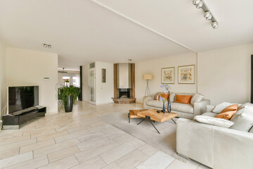 A stylish modern living room featuring elegant furniture, subtle decor, and a cozy atmosphere,...