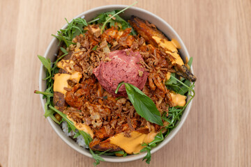 Vegan Buddha Bowl. A hearty bowl with a base of brown rice or quinoa, topped with roasted sweet potatoes, chickpeas, avocado, and a drizzle of tahini sauce