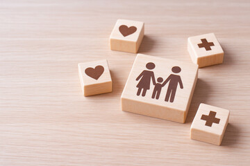 Family Medicine : Family and medicine symbols on wooden blocks convey care and health concepts