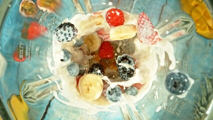 Fresh smoothie drink. Preparing smoothie in a blender. Mix of fruit and vegetable with milk.