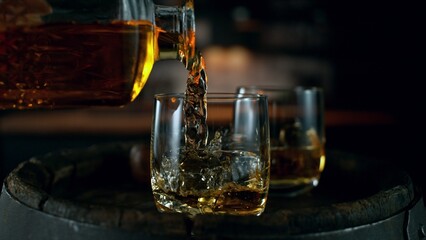 Barman pouring whiskey, closeup.