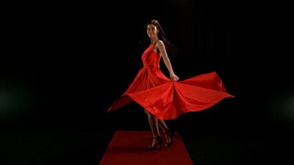 Woman in red dress dancing with flying fabric, Fashion Model Girl Posing with waving cloth