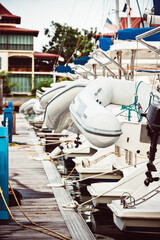 Sailboats moored at marina with inflatable dinghies, nautical theme, background