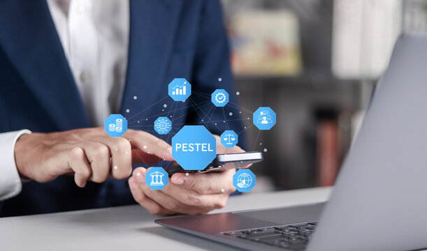 PESTEL Analysis concept. Political, Economic, Social, Technological, Environmental and Legal. Businessman with PESTEL icon on virtual screen.