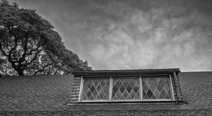 Loft Windows  on an Old Church with Overcast Skies Above.