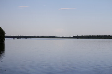 A peaceful rural landscape in spring where melting snow or rain has flooded open fields, turning them into shallow lakes.