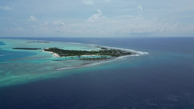 Aerial view of beautiful luxury resort at tropical island in Indian Ocean at sunny day.Awesome seascape. Drone point of view. Kuda Villingili resort. Maldives