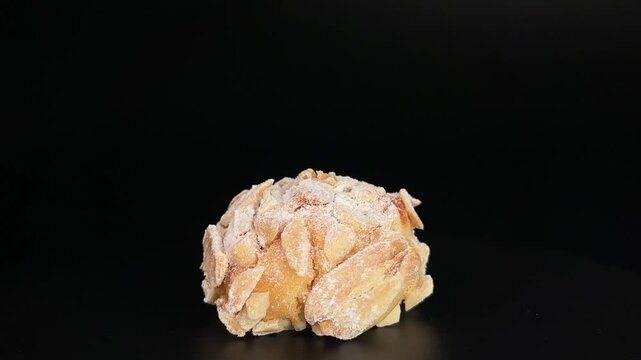 Italian almond flour cookie with large almond slices rotates 360&deg; on a black background. Perfect for bakery, dessert menus, caf&eacute; branding, or culinary promos. Crispy and delicious look.