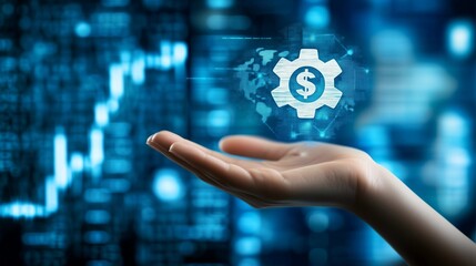Fototapeta premium Hand holding gear icon with finance symbols on blue virtual background, representing financial technology, digital innovation, business process automation, and virtual web services integration