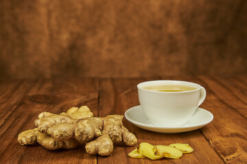 Ginger root infusion served in a teacup to combat the cold as a natural antibiotic