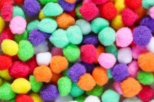 Colorful pom poms close up. DIY children home activity. Early education, fine motoric skills