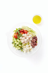 Portion of healthy greek salad bowl isolated on white background