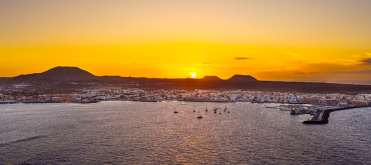 Spectacular aerial panoramic landscape image of the evening sunset sky at golden hour over the town of Corralejo, Fuerteventura, Canary Islands, Spain