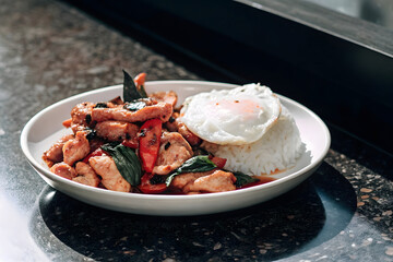 Thai Basil Chicken With Rice And Fried Egg On Whit